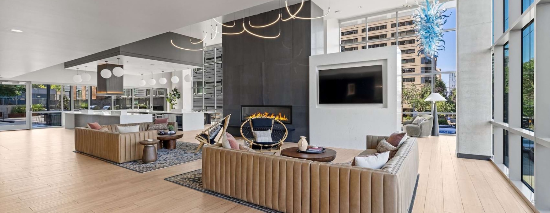 a spacious room with lounge sofas and a large fireplace