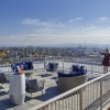 a group of people standing on a balcony overlooking a city