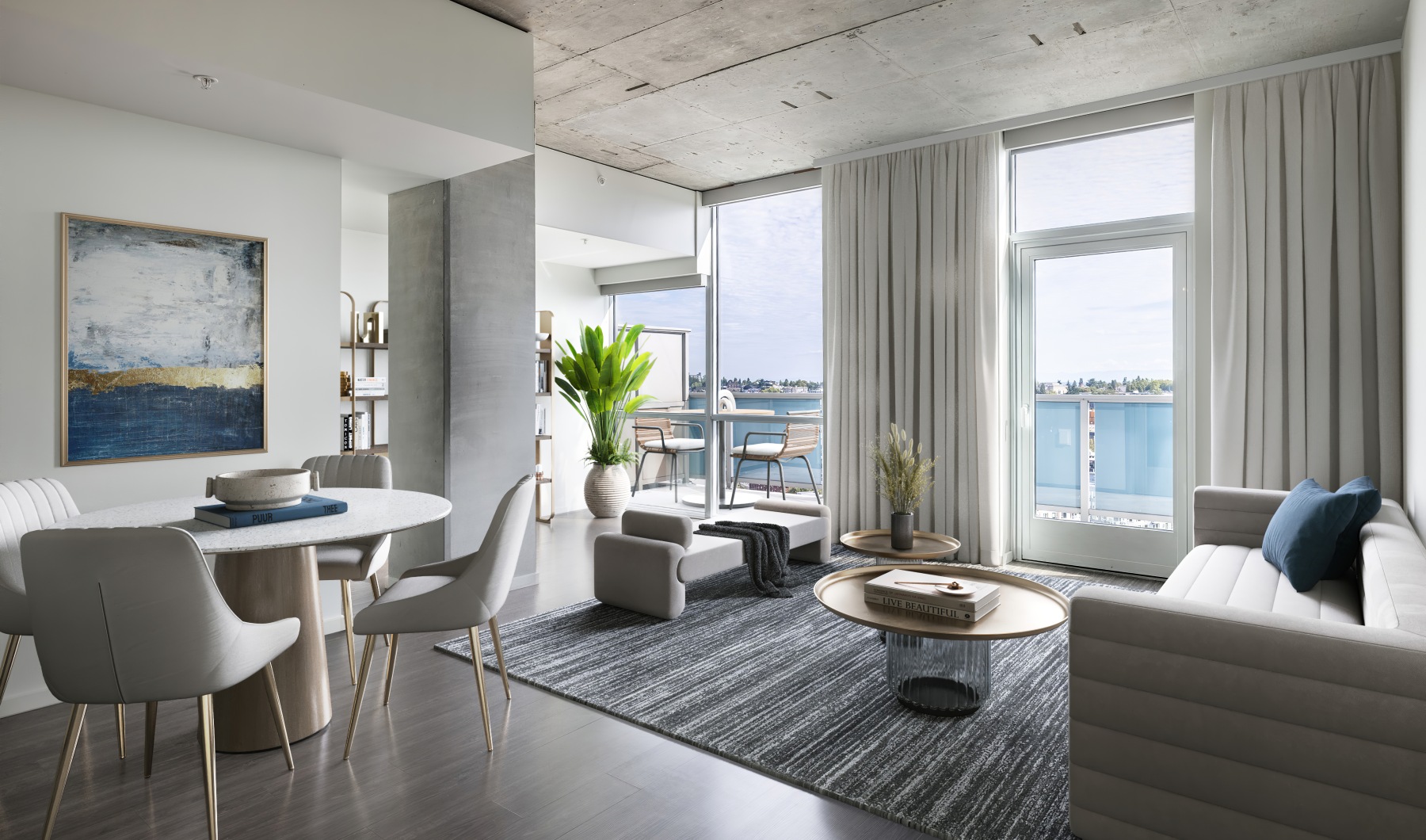 a living room with a couch, chairs and table