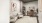 a desk and lounge chairs in a room with tall ceilings