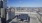 a table and chairs on a deck overlooking a city